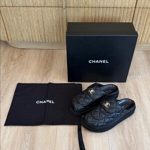 CHANEL Black Quilted Mules with Gold Logo